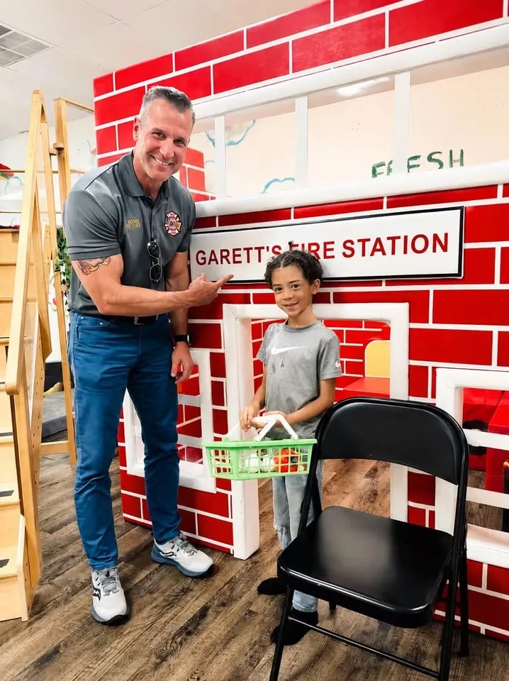 Community guest at the Fresh Play pretend fire station